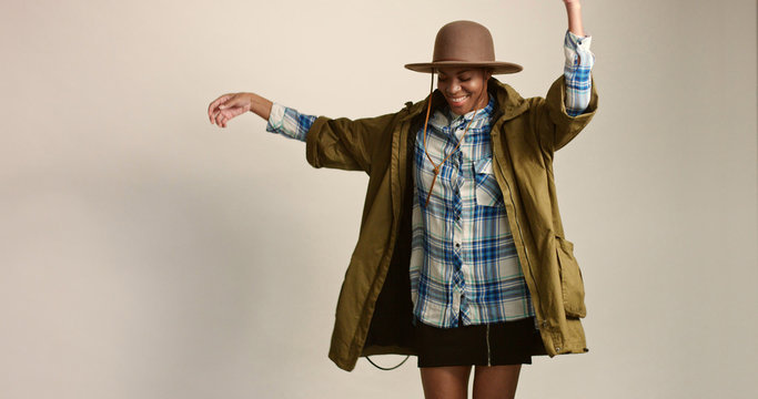 pretty mixed race woman with short hair in autumn outwear and hat