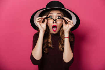 Shocked lady wearing hat and glasses