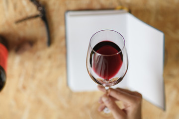 Attractive woman check red wine in white paper background