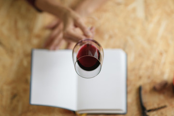 Attractive woman check red wine in white paper background