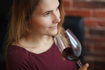 Attractive woman drink red wine in the restaurant