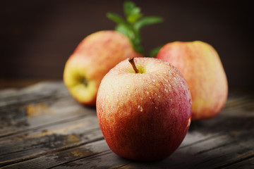 Red sweet apple and the woodan background, selective focus