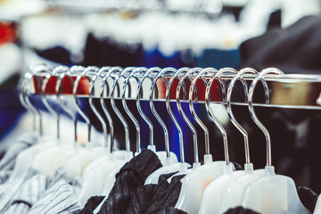 Fototapeta premium hangers in store with clothes