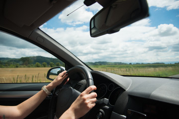 Fototapeta na wymiar Young woman driving a car