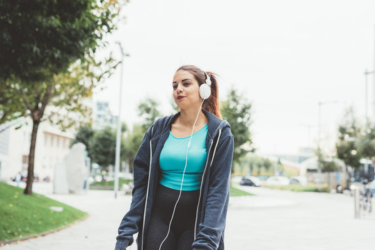 young woman mixed race outdoor walking listening music - enjoying, happiness, relaxing concept