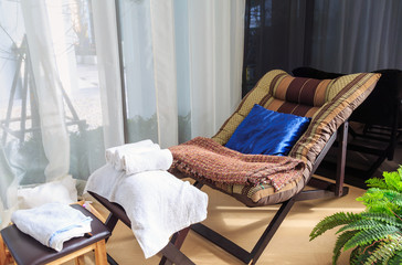White towels and massage equipment on the massage chair.