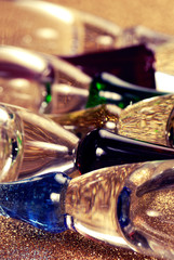 Colorful champagne glasses over gold nuggets background