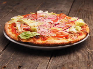 Crispy pizza on a rustic wooden table