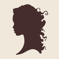 Obraz na płótnie Canvas Silhouette of beautiful curly african woman in profile isolated vector illustration. Beauty salon or hair product logo design