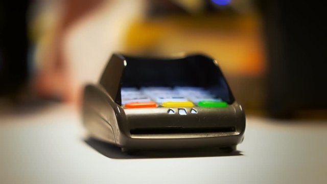 Man is paying with contactless credit card.