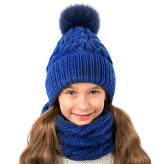 Beautiful little girl in winter warm blue hat and scarf isolated on white. Children winter clothes