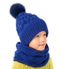 Beautiful little boy in winter warm blue hat and scarf isolated on white. Children winter clothes