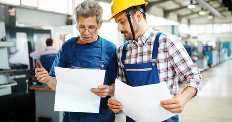 Supplier with engineer checking on production in factory