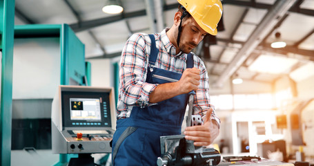 Male worker and quality control inspection in factory