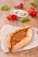 Turkish pide pizza with meat and onion.