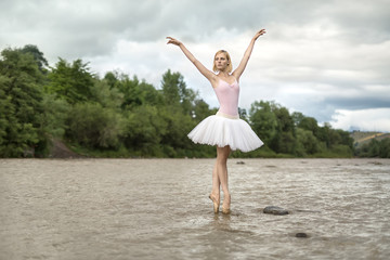 Fototapeta na wymiar Ballerina posing in river