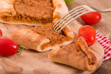 Turkish pide pizza with meat and onion.