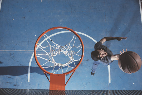 Man catching ball under hoop