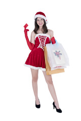 Christmas concept : Beautiful smiling young Asian woman in Santa Claus costume holding credit card and shopping bags full of Christmas gifts  isolated on white background