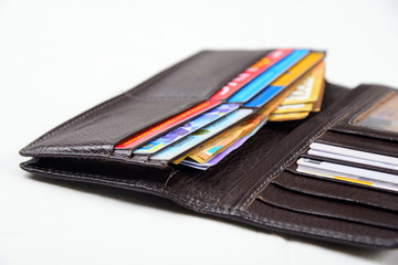 Dark brown wallet isolated and money