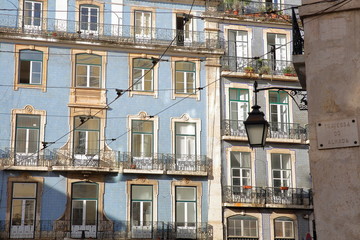 Obraz premium Colorful facades with wrought iron railing balconies in Alfama neighborhood, Lisbon, Portugal