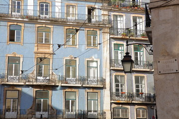 Colorful facades with wrought iron railing balconies in Alfama neighborhood, Lisbon, Portugal