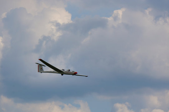 glider in the sky with some clouds