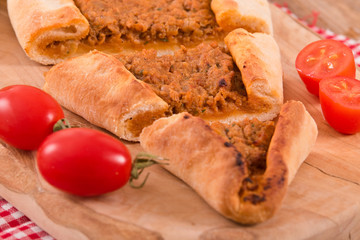 Turkish pide pizza with meat and onion.