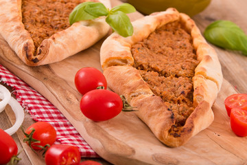 Turkish pide pizza with meat and onion.