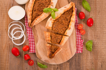 Turkish pide pizza with meat and onion.