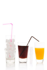 Cola, sugar cubes and orange juice in glass.
