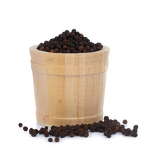 Black pepper in wooden bowl isolated on white background