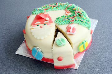 slice, portion of handmade decorated with sugar paste, fondant christmas cake: cut of banana and...