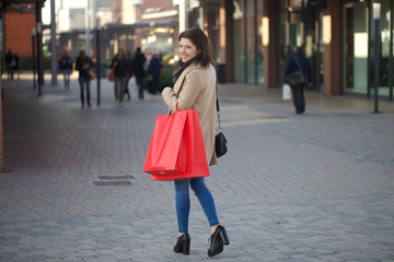 Fototapeta premium young woman doing shopping in outdoor shopping mall