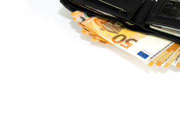 Open black leather wallet with many fifty euro banknotes inside isolated on white background.