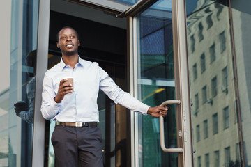 Portrait of a confident young black businessman with take away coffee