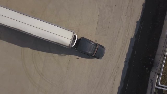 Top view truck with freight container parking for unloading in storage building