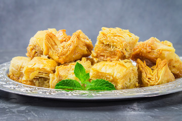 baklava turkish traditional delight on a dark wood background. toning.