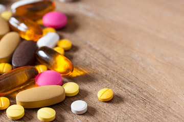Fototapeta na wymiar Close up of medicine tablets on a wooden background