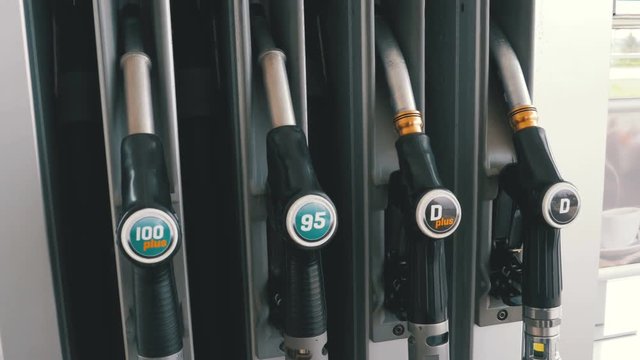 Gasoline or petrol station gas fuel pump nozzle. Filling or Petrol station. Various pistols for fuel at the gas station. Different Gasoline gun at a petrol station. Gas fuel pump nozzle.