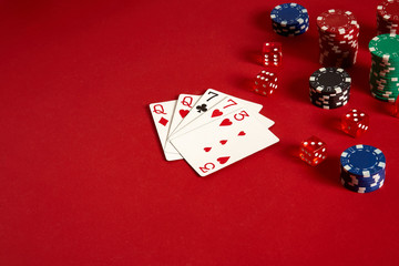 Poker cards and gambling chips on red background