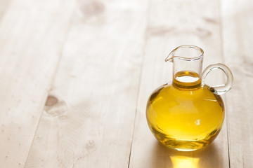 Fish oil in a jug on wooden texture and table