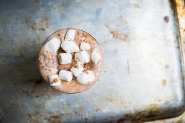 Obraz na płótnie Canvas Hot chocolate with marshmallow on the wooden background. Shallow depth of field. Toned image.