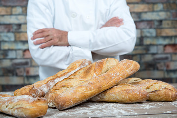 baker with traditional bread french baguettes