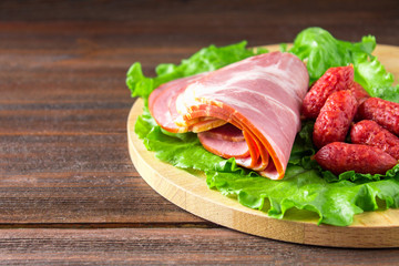 Assorted meat products including ham and sausages.