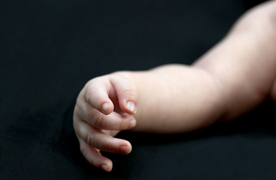 baby arm and hand isolated on a black background