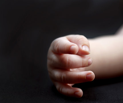 baby arm and hand isolated on a black background