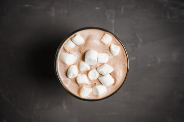 Hot chocolate with marshmallow on the wooden background. Shallow depth of field. Toned image.