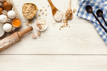 Baking background with eggs and flour on white rustic wood