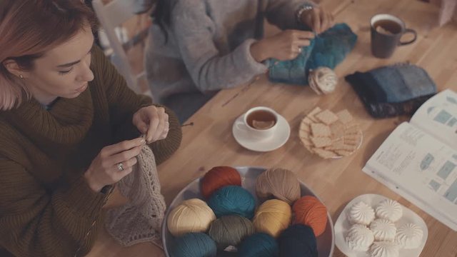 Young women knitting in studio